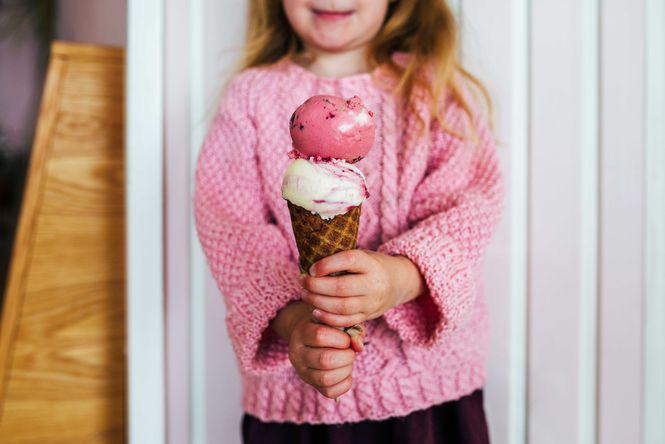 A girl holding ice cream.